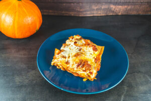 Stück einer vegetarischen Kürbis-Lasagne auf einem Teller