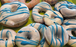 Donuts aus dem Donut-Maker und der Heißluftfritteuse mit weißer Glasur und blauen Streifen