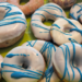 Donuts aus dem Donut-Maker und der Heißluftfritteuse mit weißer Glasur und blauen Streifen
